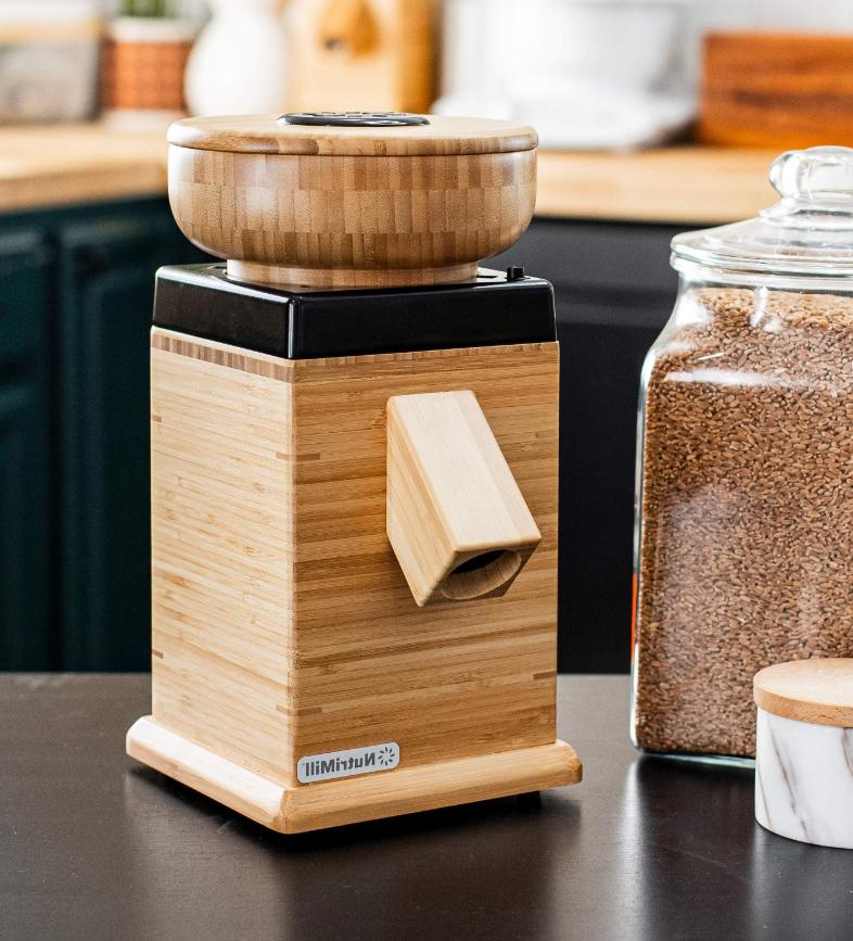 NutriMill Harvest Grain Mill-Black with jar of grain