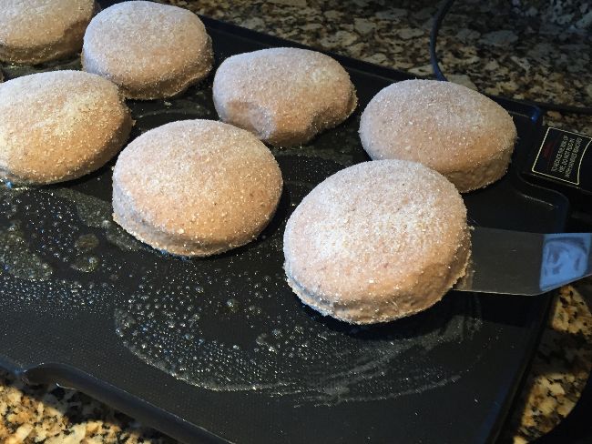 Gently place muffin rounds on griddle