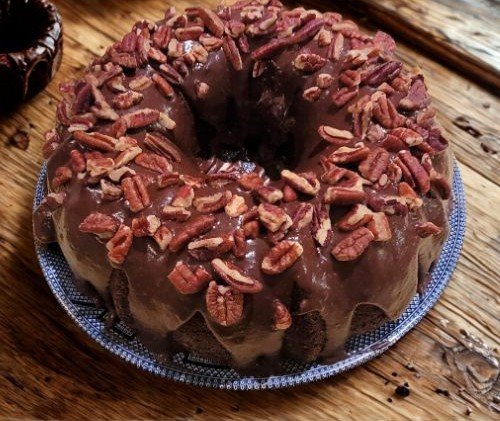 Pecan Covered Chocolicious Chocolate Bunt Cake on Wooden Table